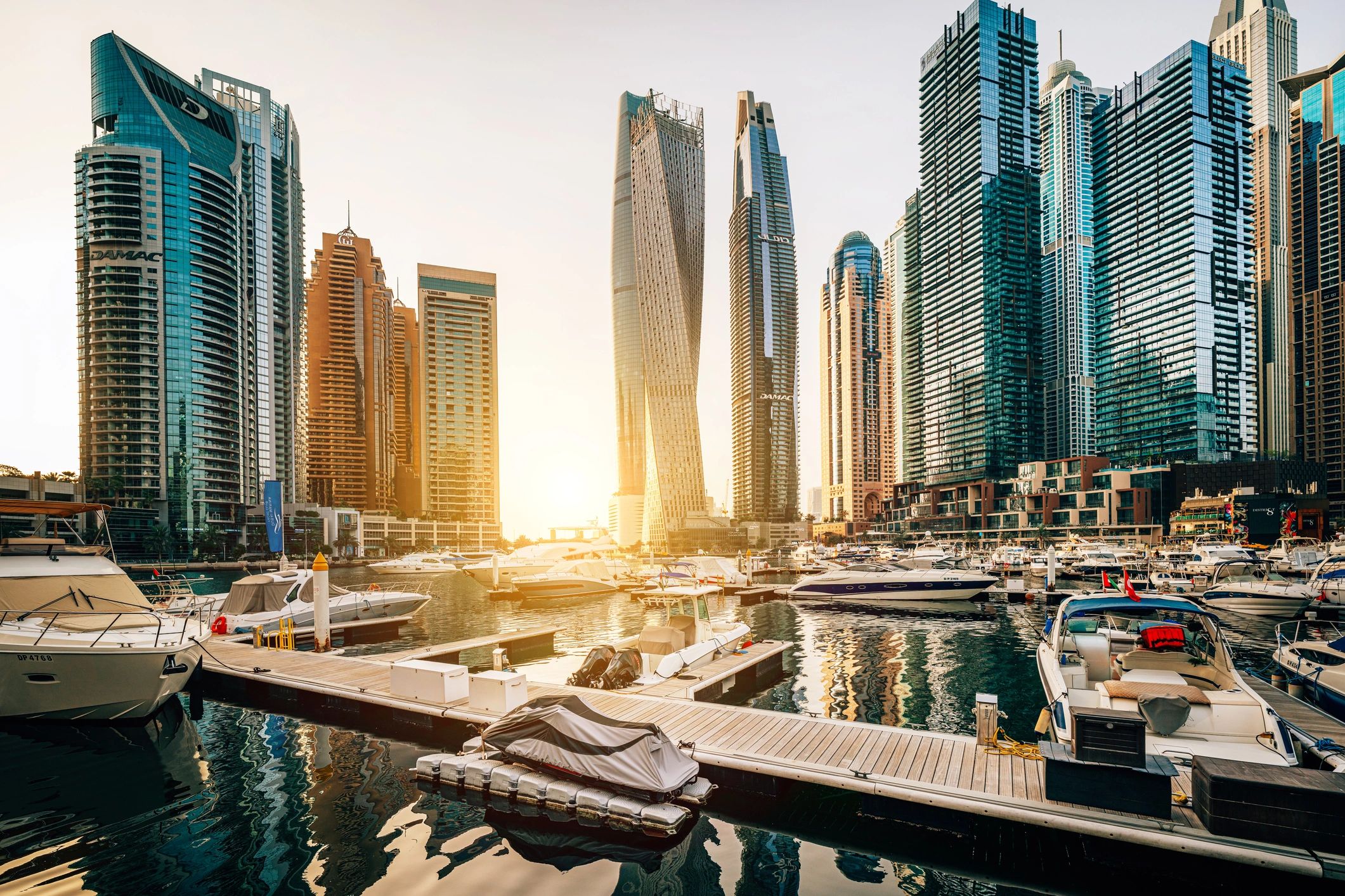 Luxury yachts at a marina at sunset